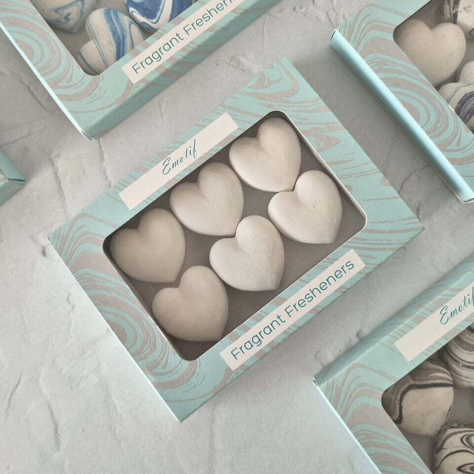 Heart-shaped fragrant fresheners in a box with Emotif branding on a light gray background.