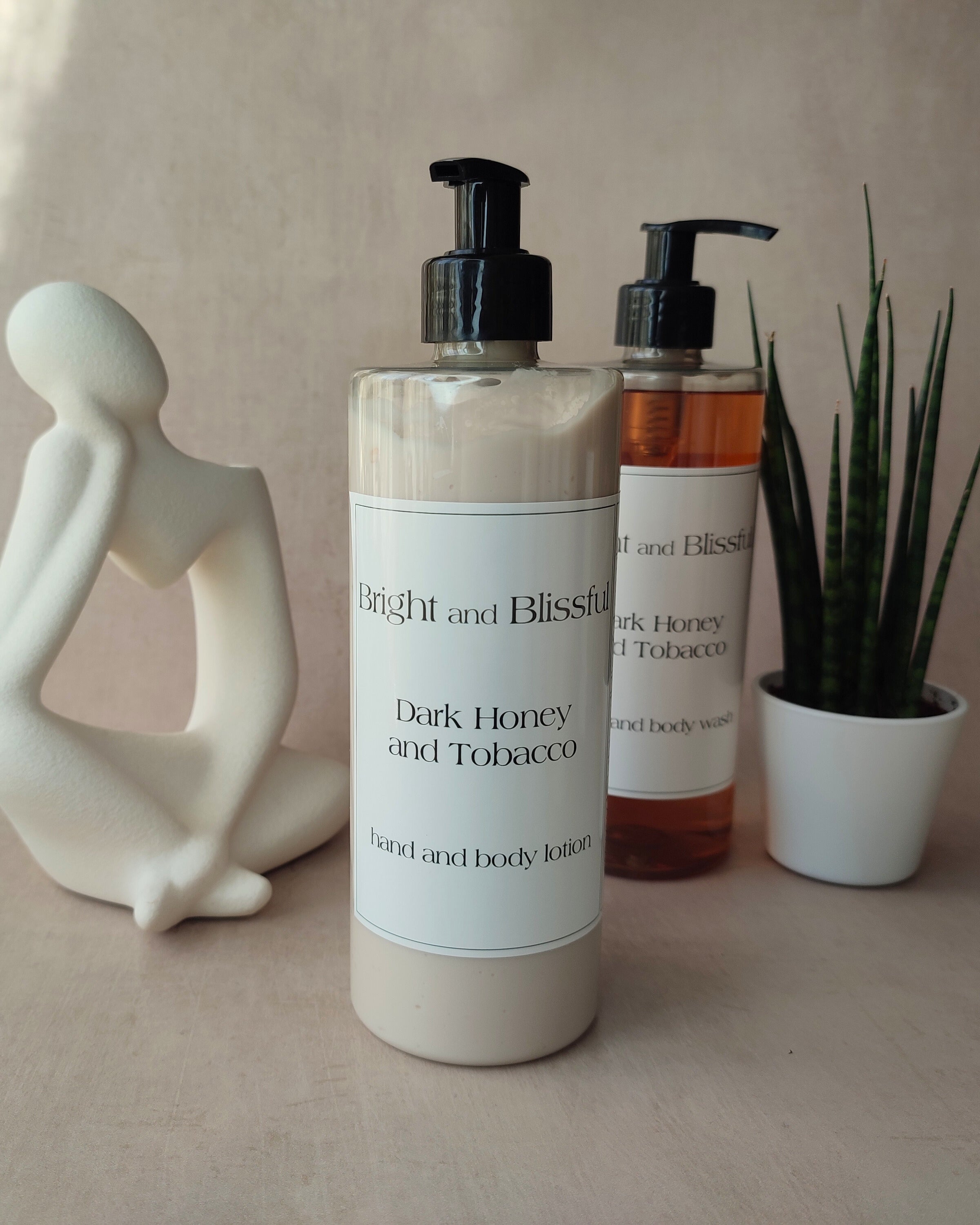 Two bottles of 'Bright and Blissful' products on a neutral background with decorative items.
