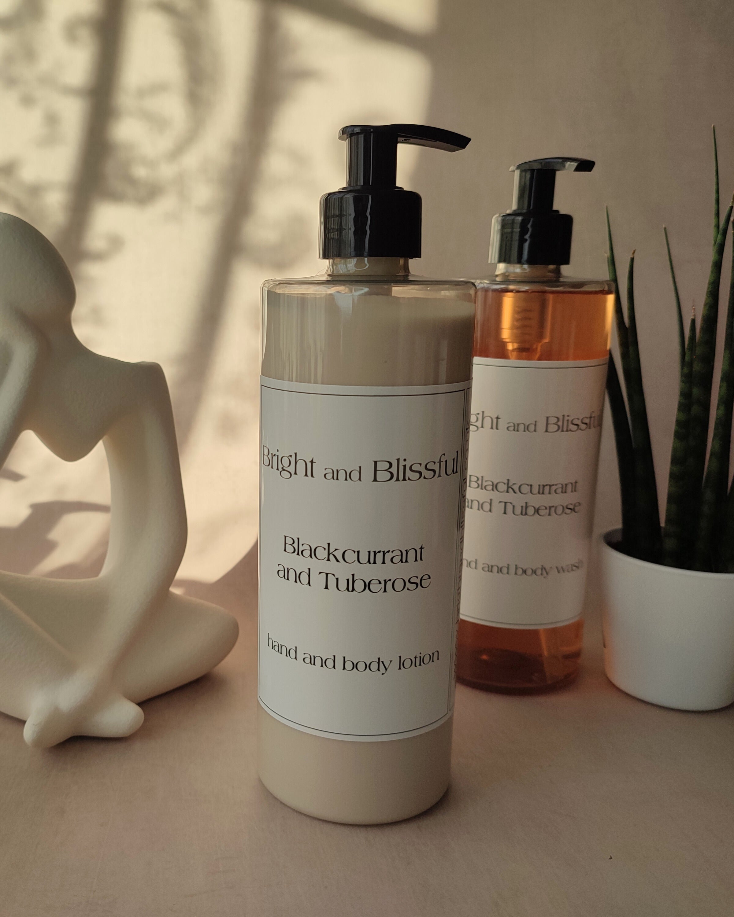 Two bottles of 'Bright and Blissful' skincare products on a surface with a neutral background.