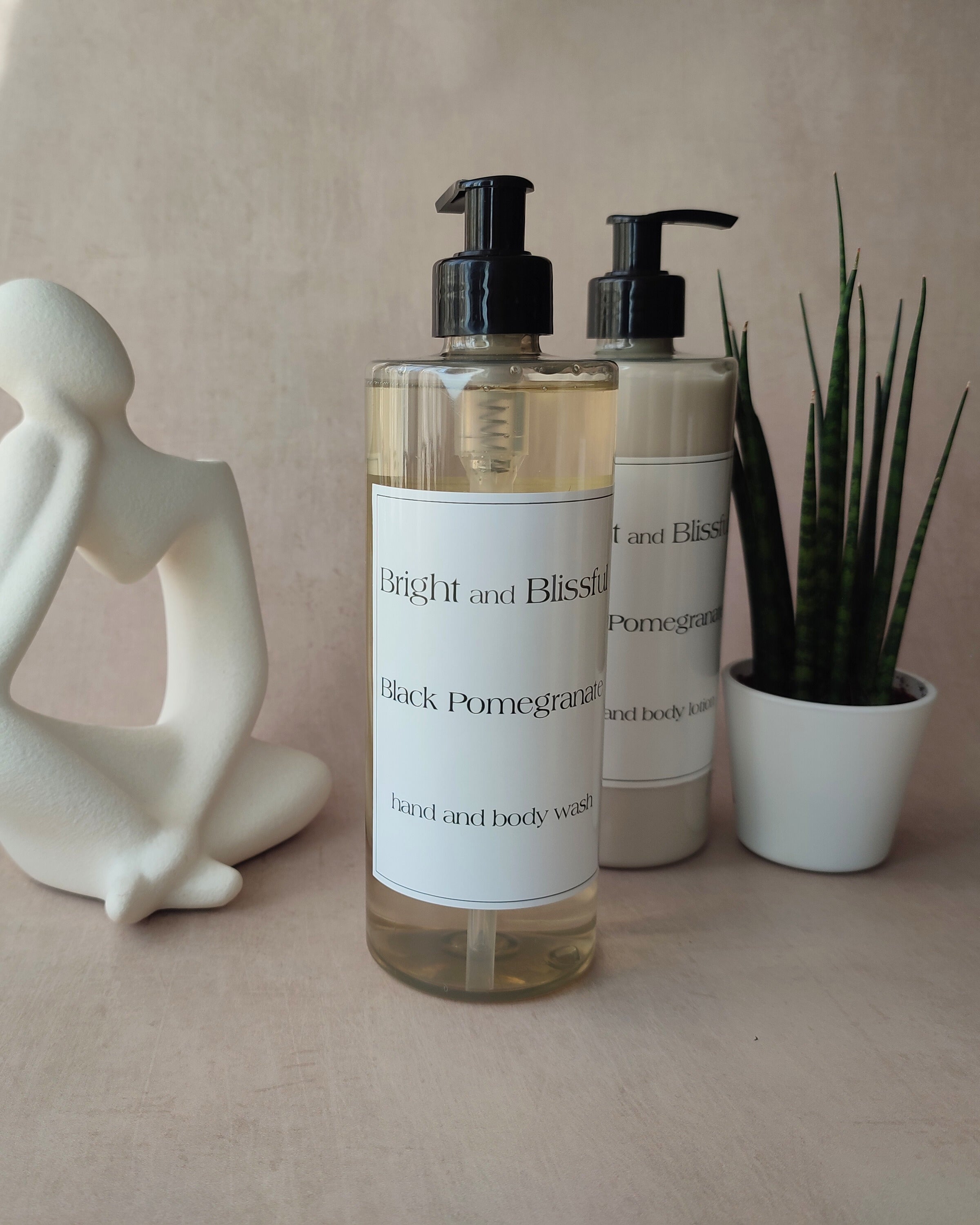 Two bottles of 'Bright and Blissful' body wash on a neutral background with decorative items.
