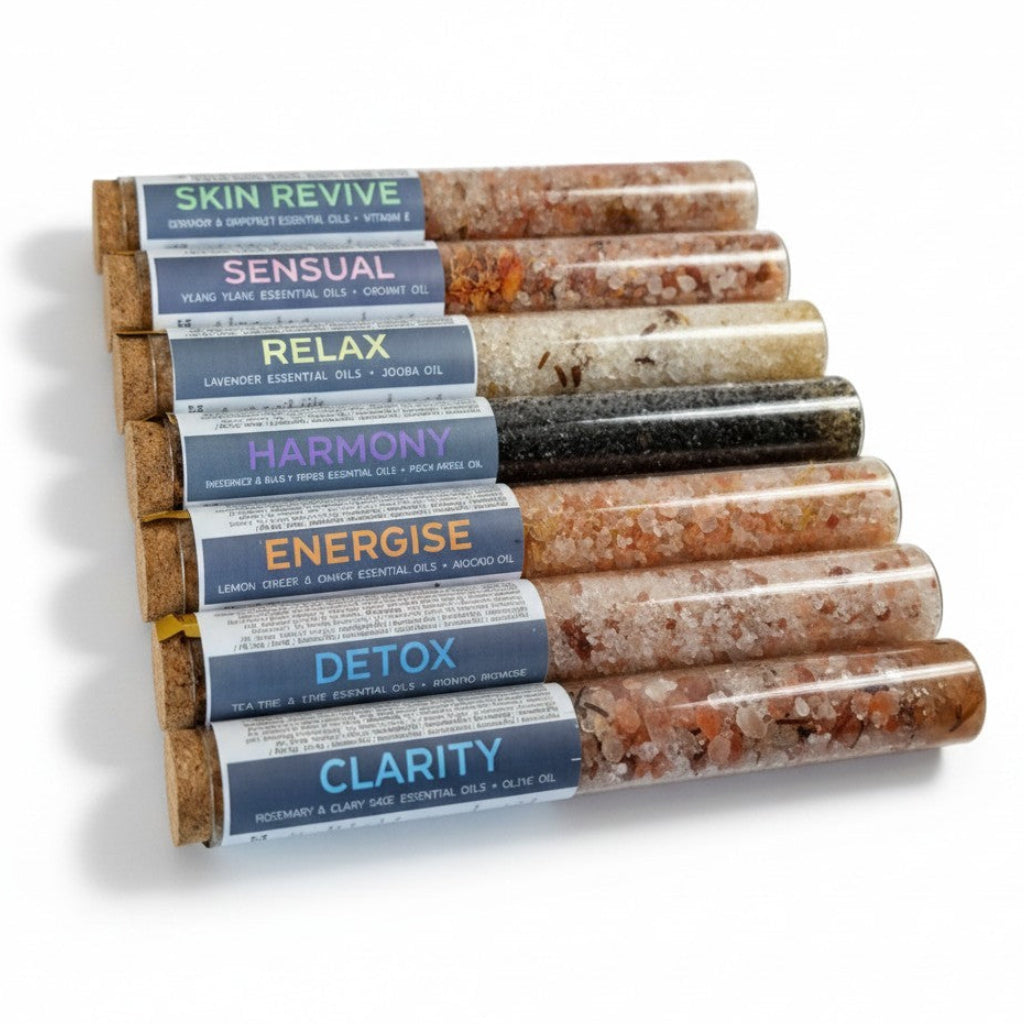 Set of test tubes filled with baths salts and essential oils various colours on a white background