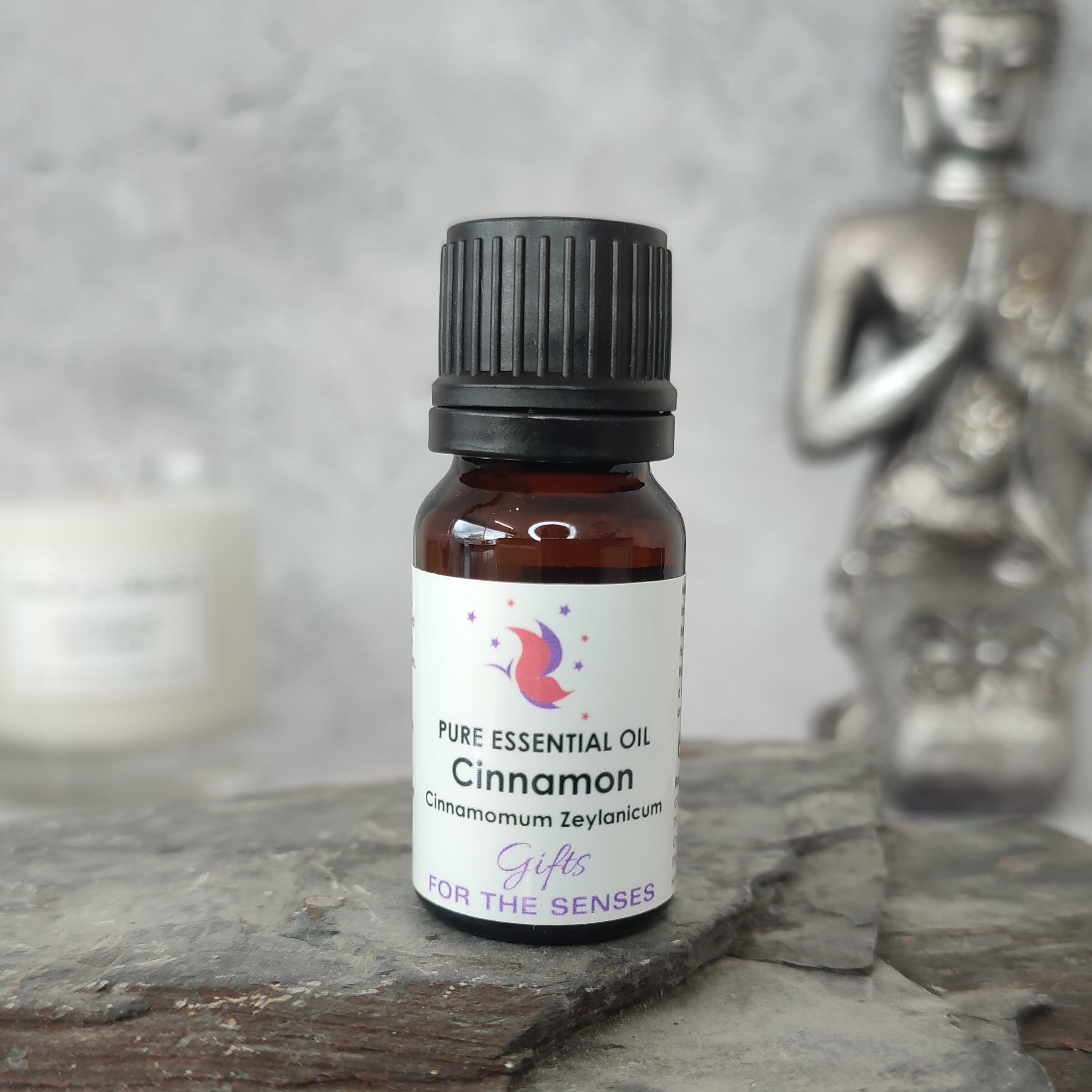 Bottle of cinnamon essential oil on a wooden surface with a blurred background