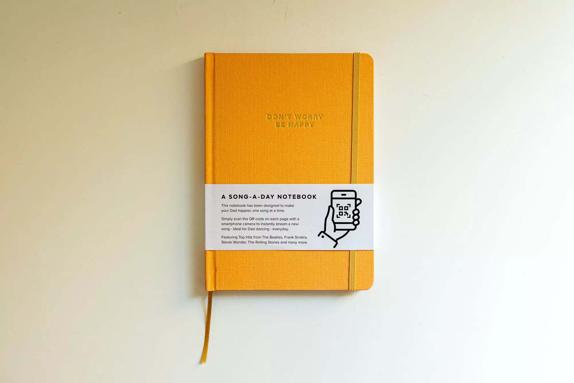 Yellow notebook with a label on a white background