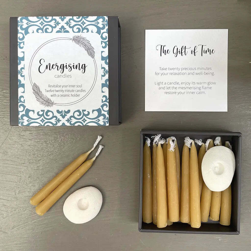 Set of candles with packaging and instructions on a wooden surface