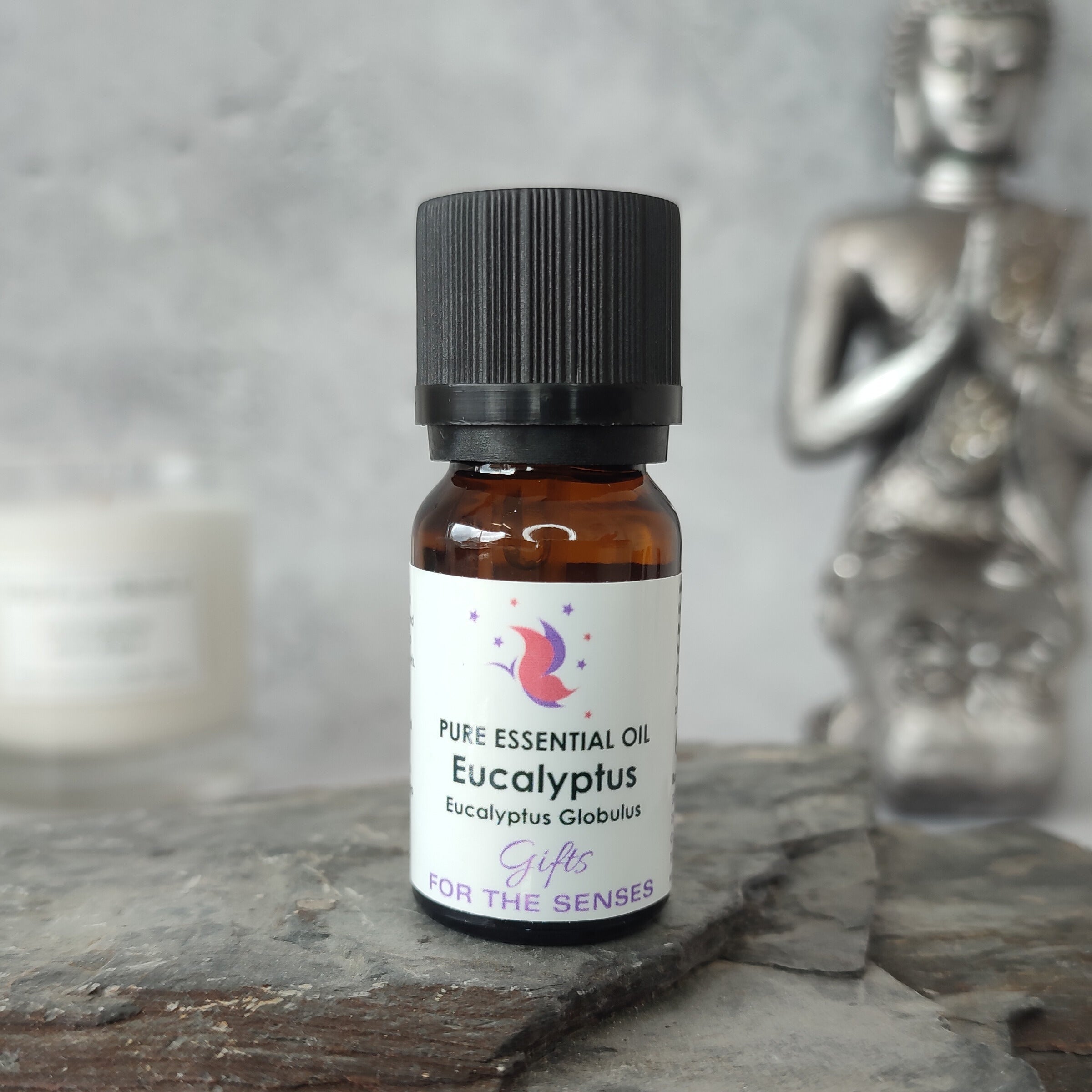 Bottle of Eucalyptus essential oil on a wooden surface with a blurred background
