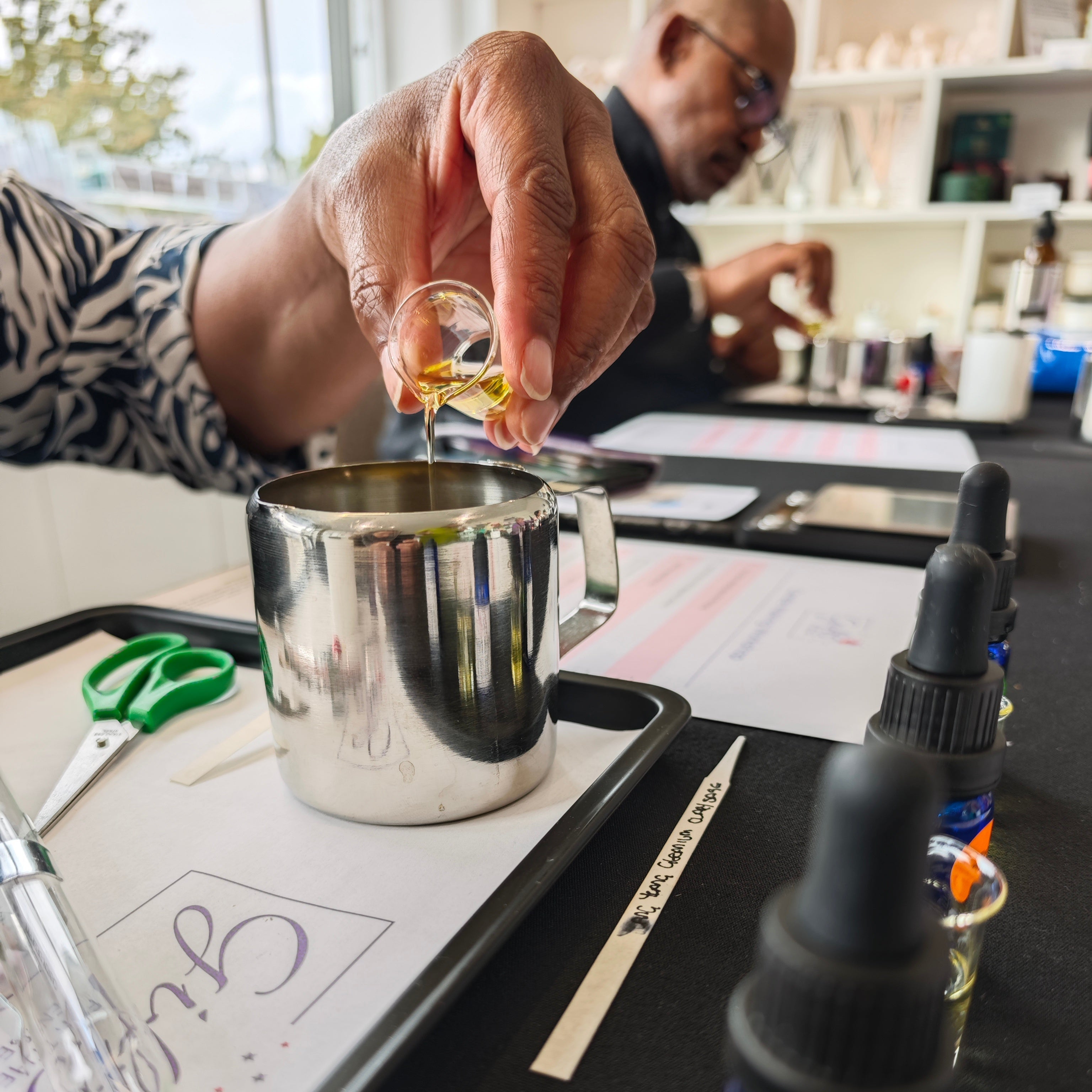 Person measuring liquid with a dropper in a laboratory setting