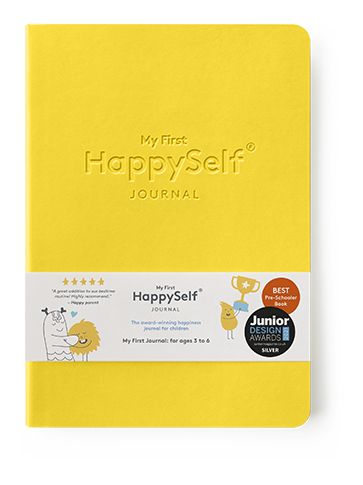 Yellow journal titled 'My First HappySelf Journal' with branding and award badges on a white background