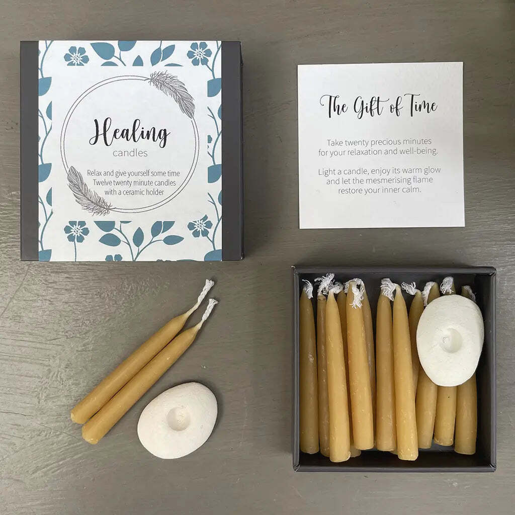 Healing candles set with packaging and instructions on a gray surface
