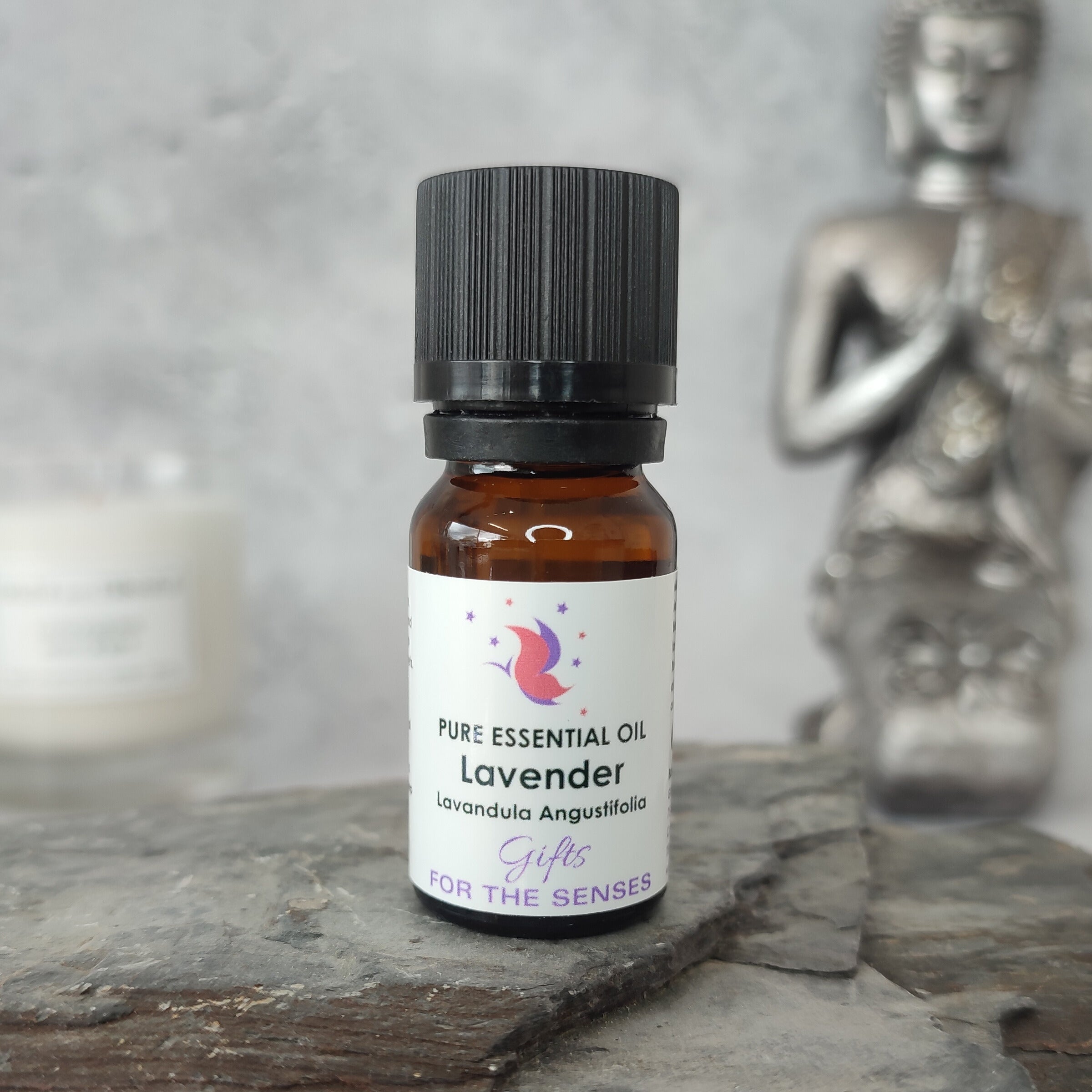 Bottle of lavender essential oil on a stone surface with a blurred background