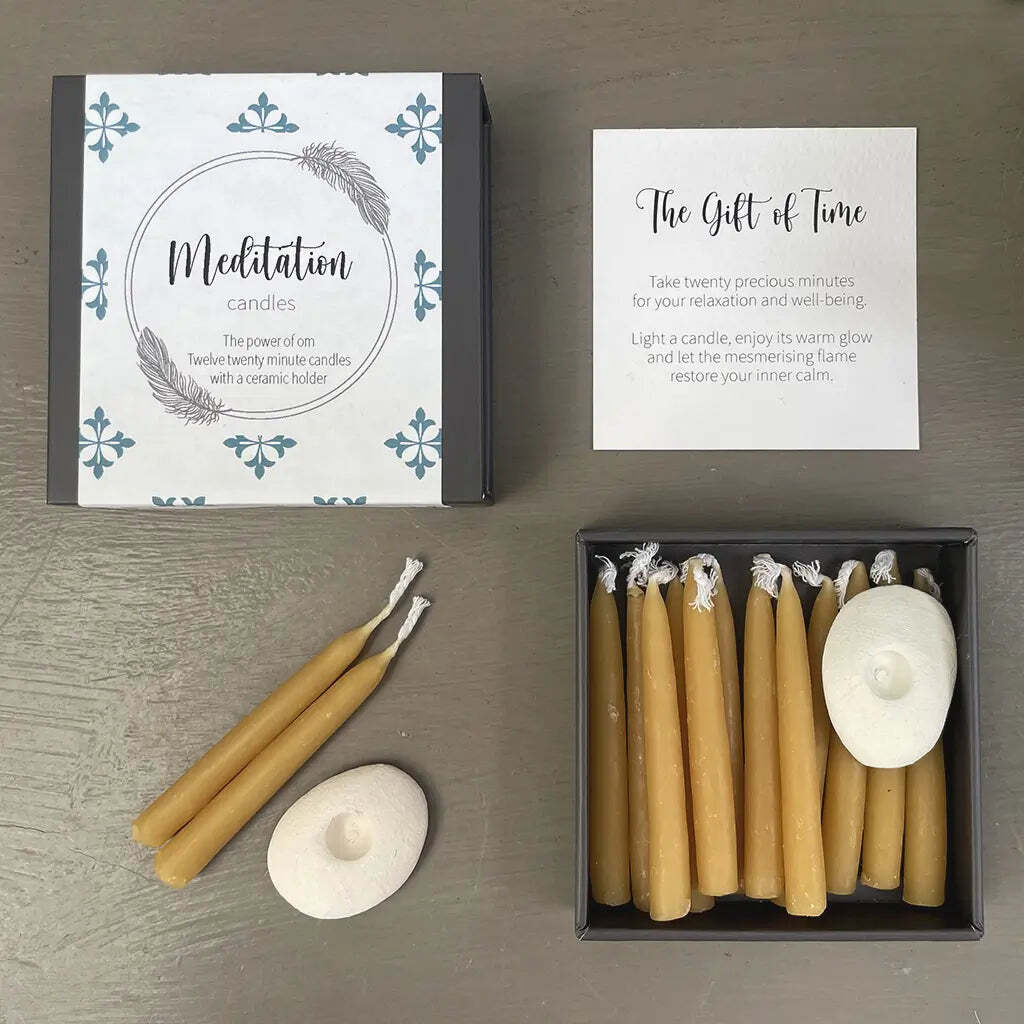 Meditation candles set with packaging and instructions on a wooden surface