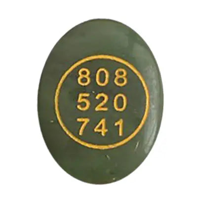 Green stone with gold numbers '808 520 741' on a white background