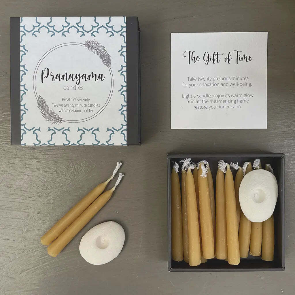 Pranayama candles with packaging and instructions on a gray surface