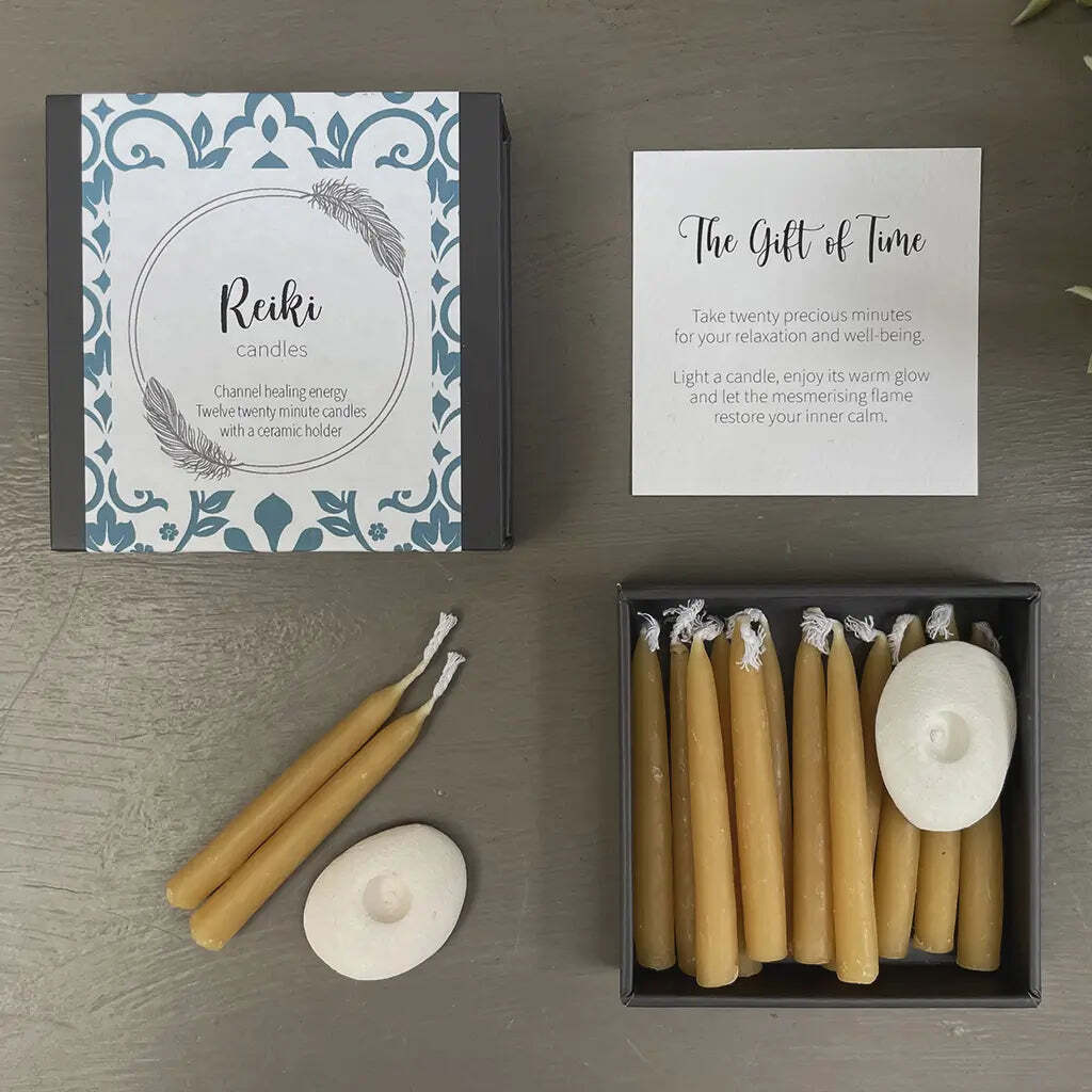 Set of Reiki candles with packaging and instructions on a wooden surface