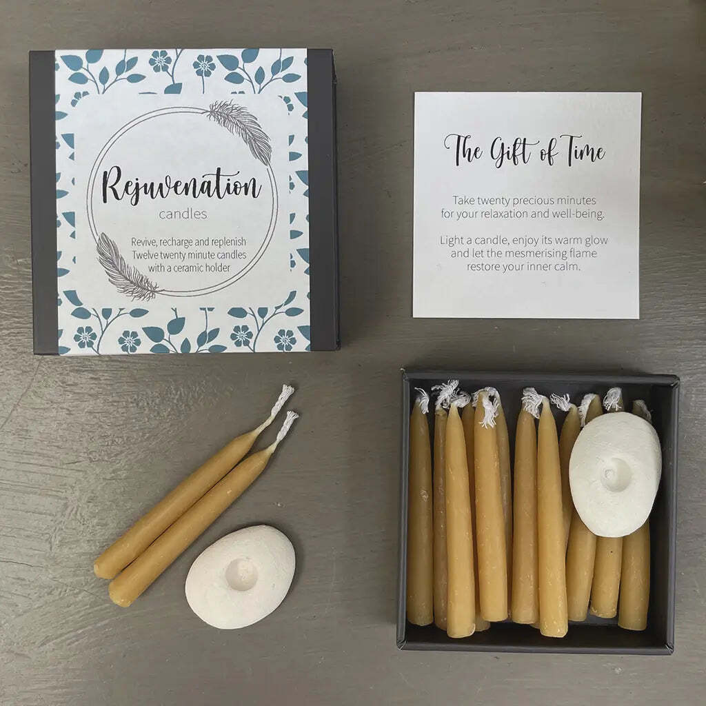 Set of beeswax candles with packaging and instructions on a wooden surface
