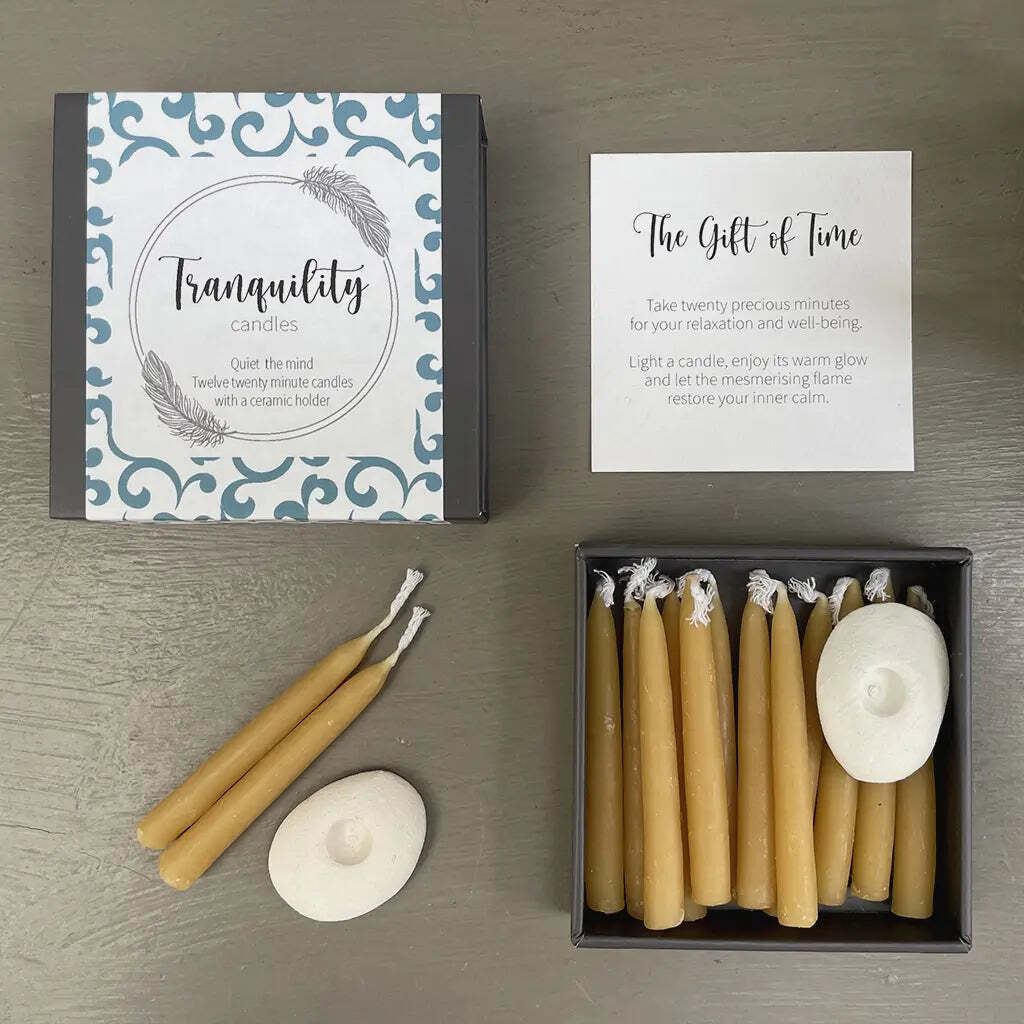 Candle set with packaging and instructions on a wooden surface