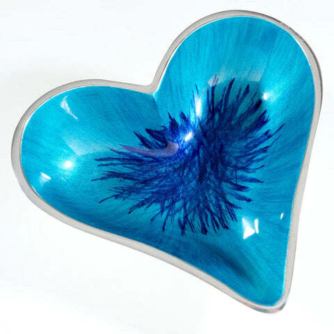 Heart-shaped object with blue interior and silver rim on a white background
