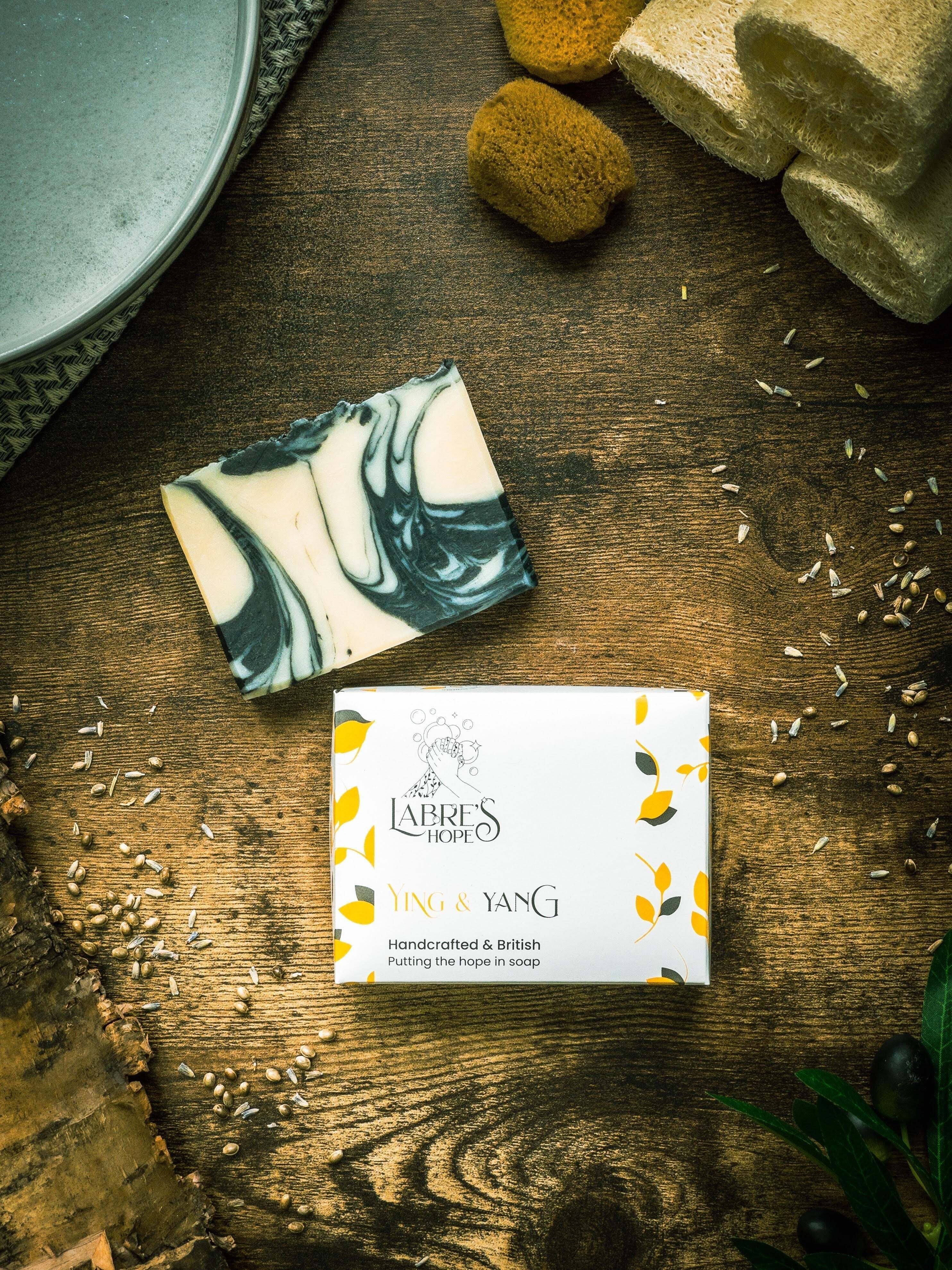 Marble-patterned soap bars and a box labeled 'Ying & Ylang' on a wooden surface.